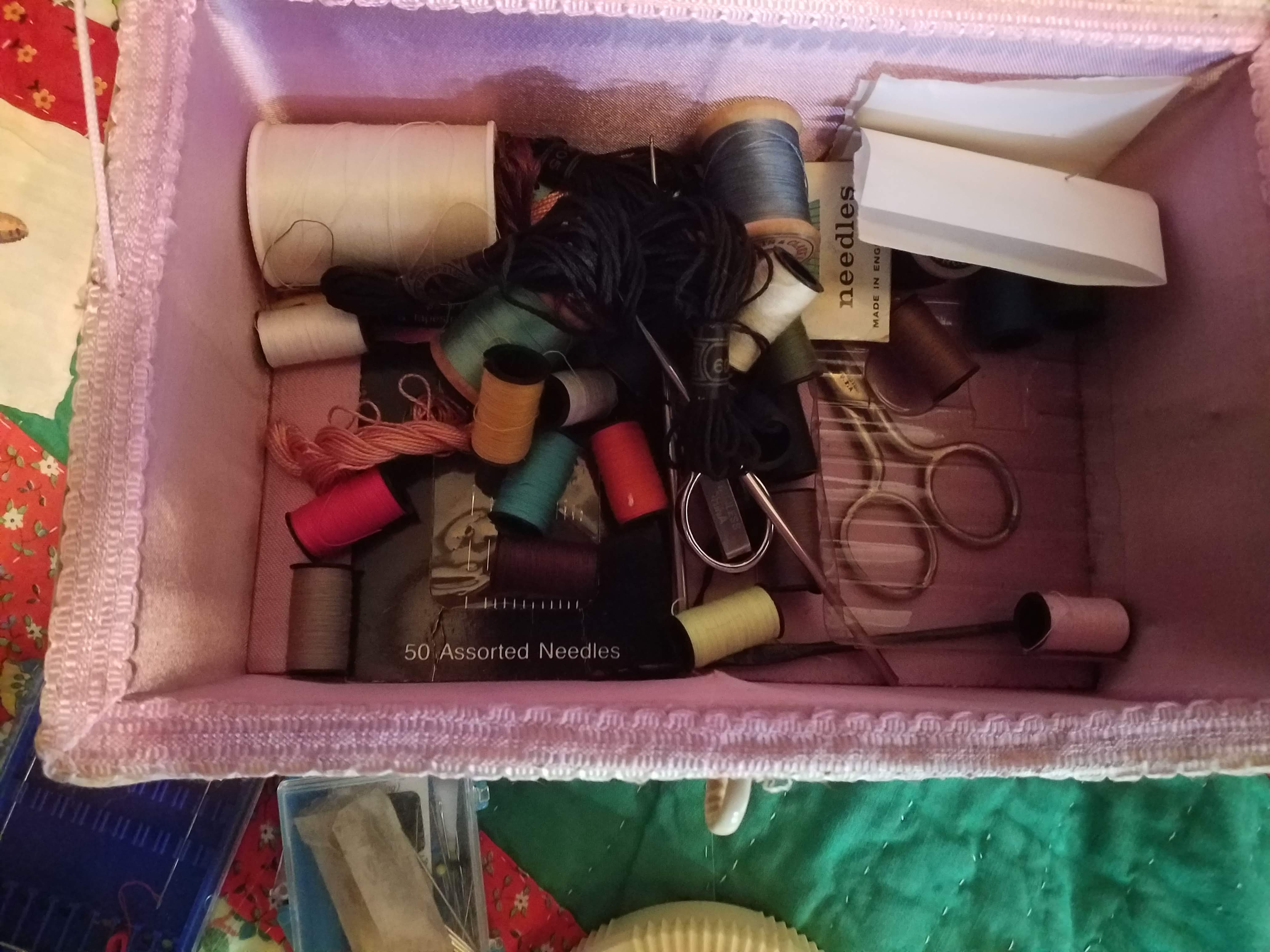 Close-up of thread and scissors in sewing box