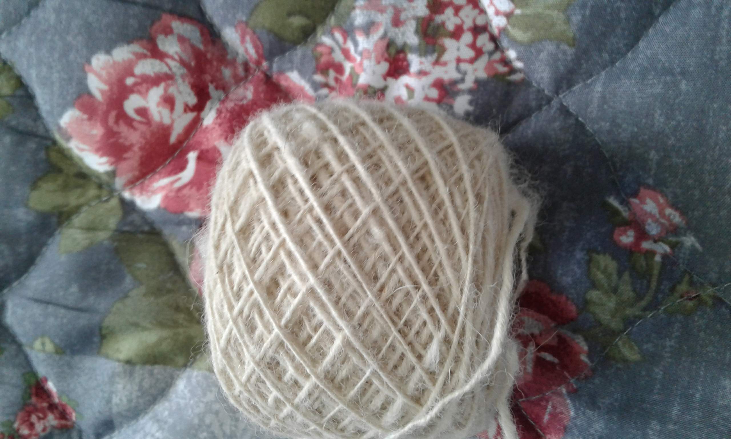 Homespun yarn on floral quilt
