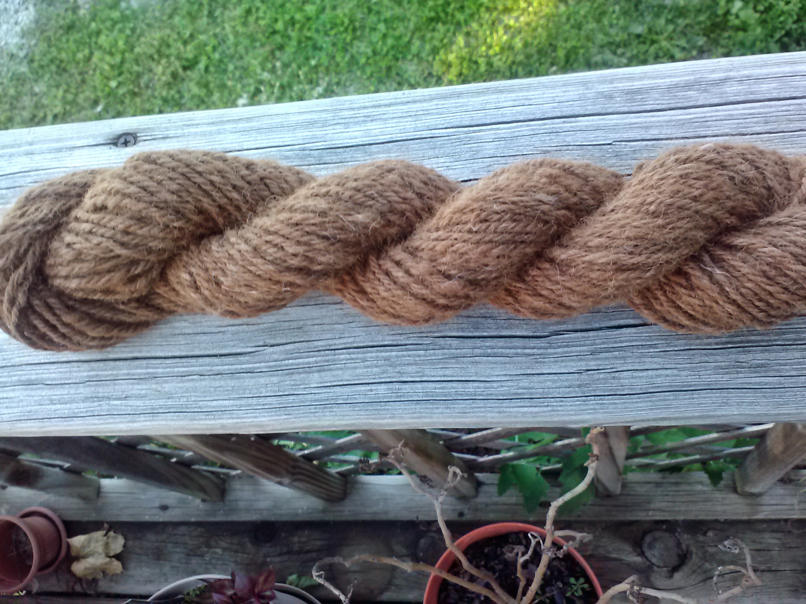Handspun yarn on wooden railing