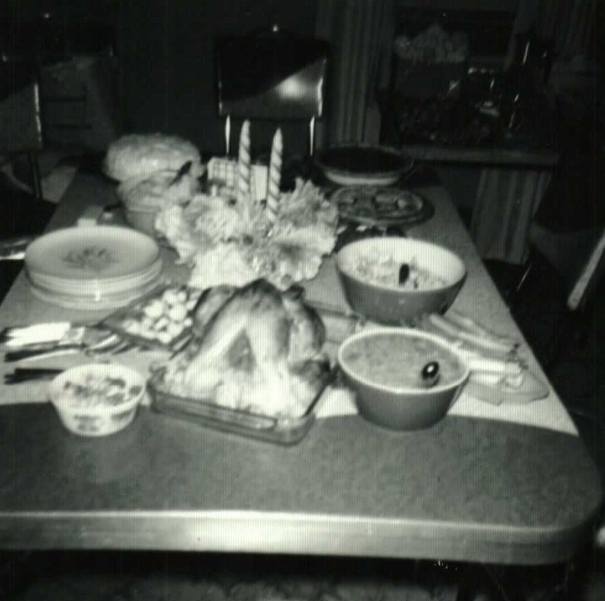 Thanksgiving meal at Grandma Doan’s house, 1961, with turkey, bowls of food, and candles on the table
