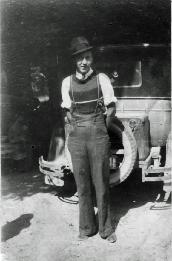Cecil Hurl standing in front of a car in suspenders