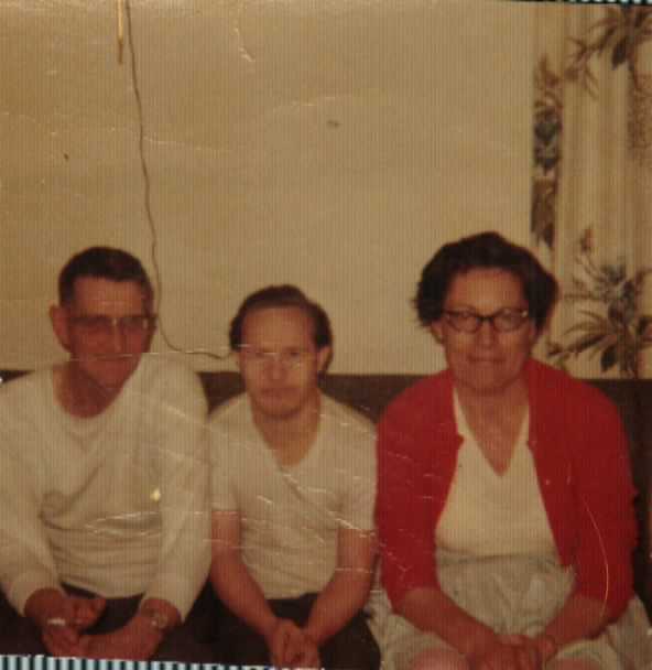 Elmer, Gilbert, and Mary Doan sitting on a couch