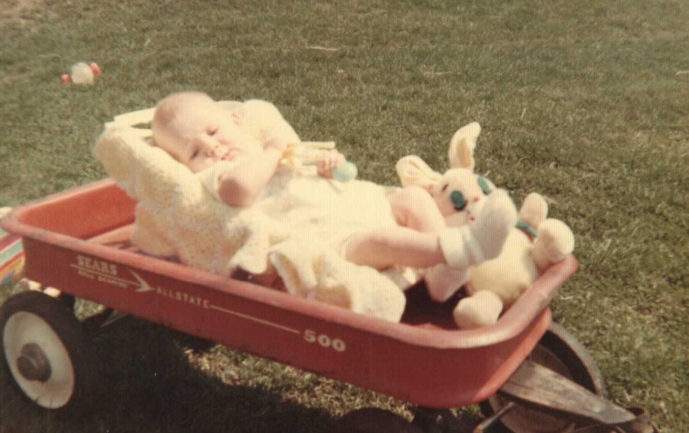 Baby Amy Rogers in yellow with bunny toy