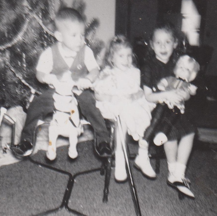 Phillip Doan, Rebecca, and Mischelle by the Christmas tree