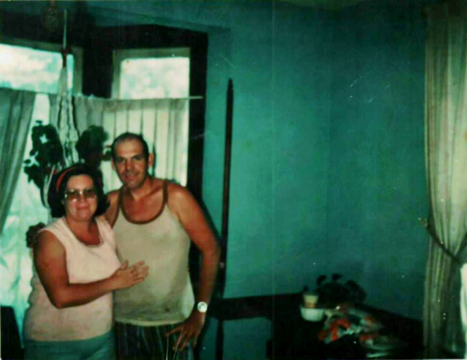 Virginia Rogers and Ronnie Kain standing in the bay window room
