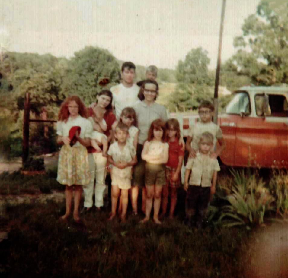 Group photo of Rogers and Holder cousins with red truck in Kentucky, 1969
