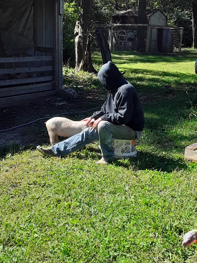The feller sitting on a bucket scratching Sally’s head